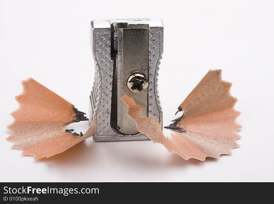 A sharpener and chips on white background