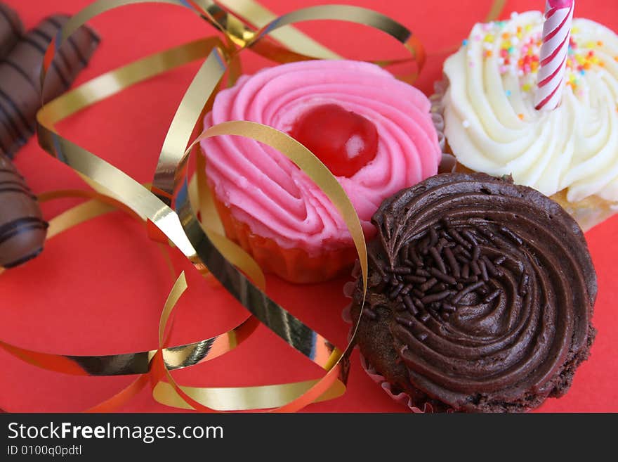 Birthday Cupcake with one candle and gold ribbon