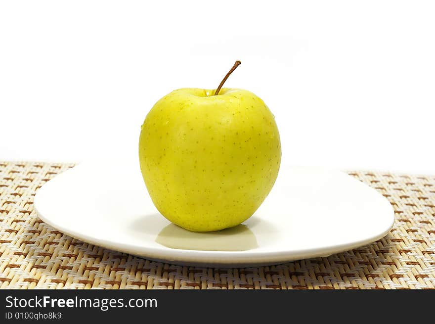 Apple On The White Plate Isolated