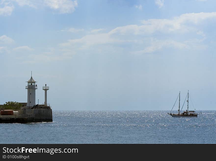 A small ship arriving at a port. A small ship arriving at a port