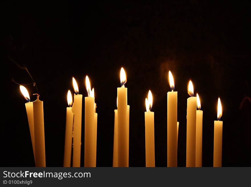 Composition of Candles with flames moved by the wind