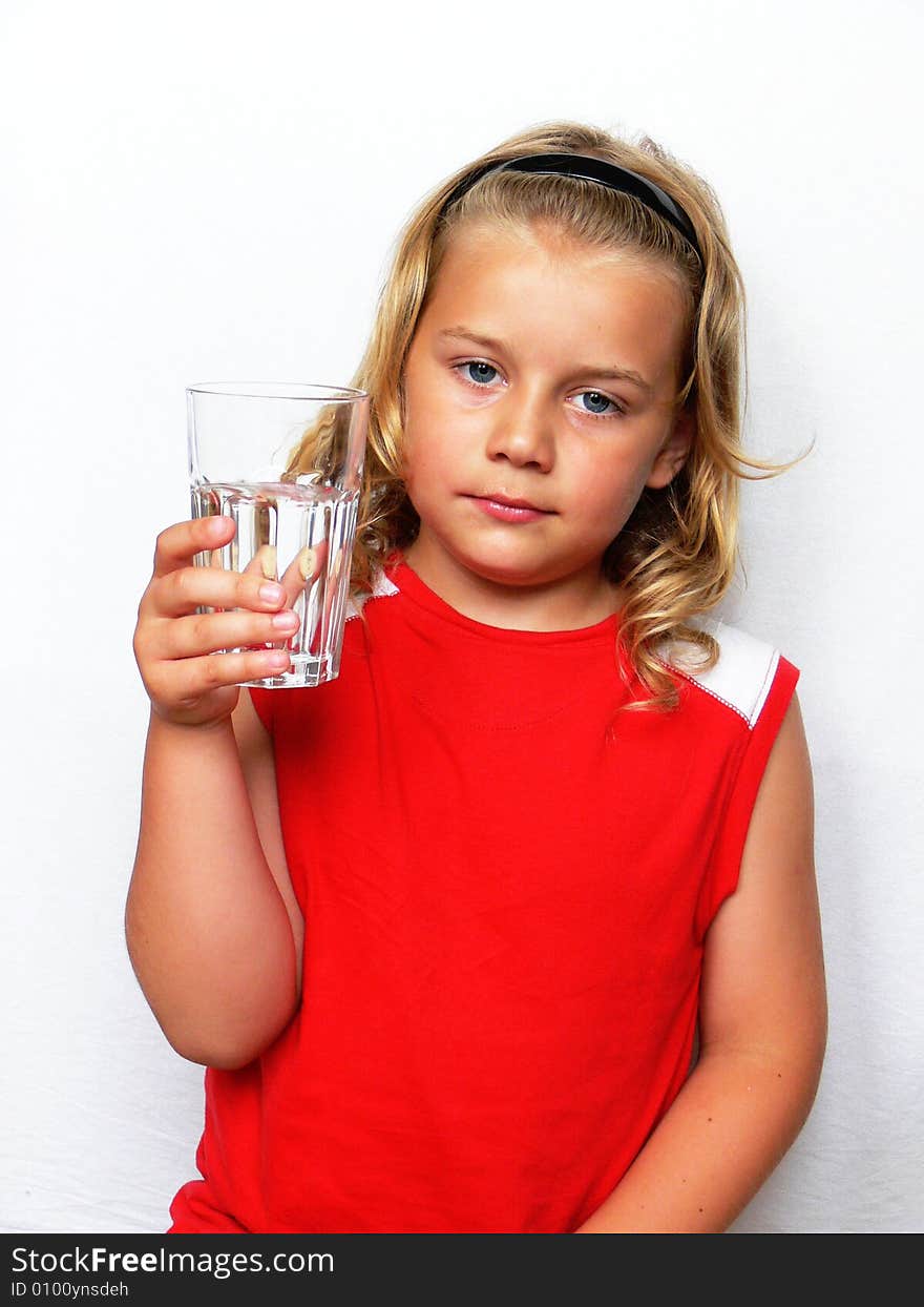 Boy showing a glass of water on a white background. Boy showing a glass of water on a white background.