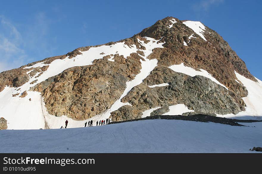 Hikers on the cliff in mountain, Backpackers silhouette