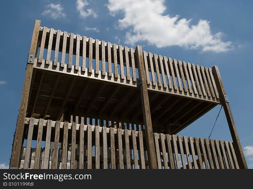 Wooden double deck against blue sky.