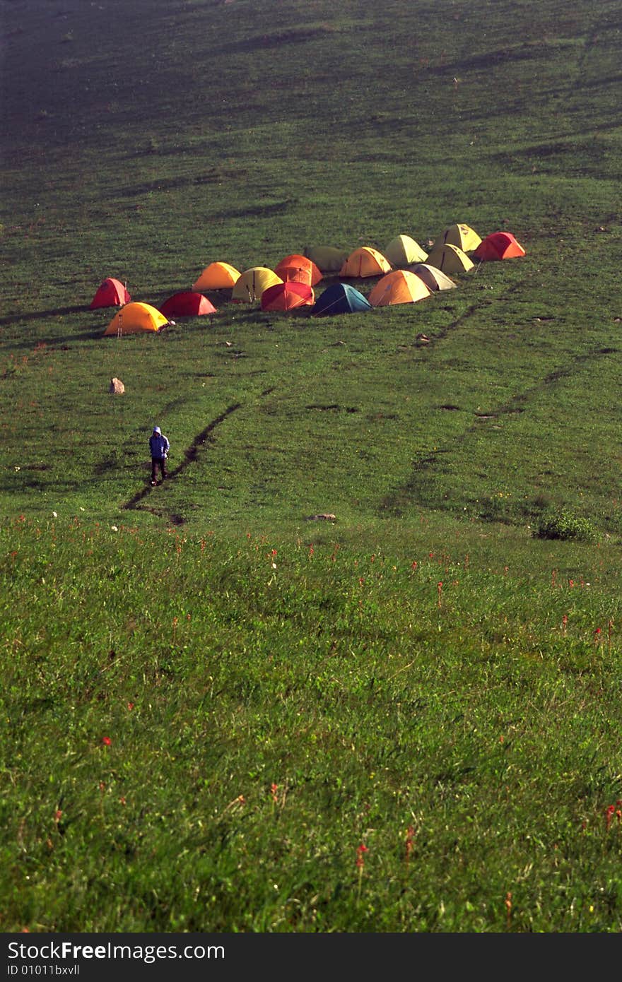 Colorful tents and traveller on the mountain. Colorful tents and traveller on the mountain