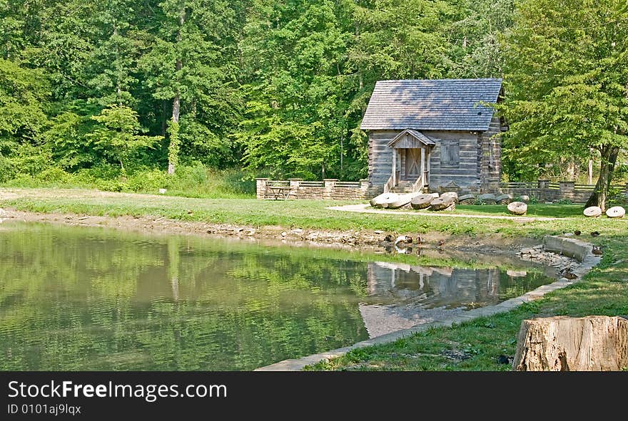 An old weathered mill on a pond. An old weathered mill on a pond
