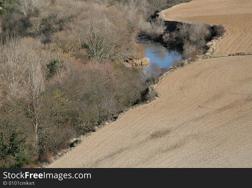 Fields and forest along a river in Foz de Lumbier, Navarra, Spain