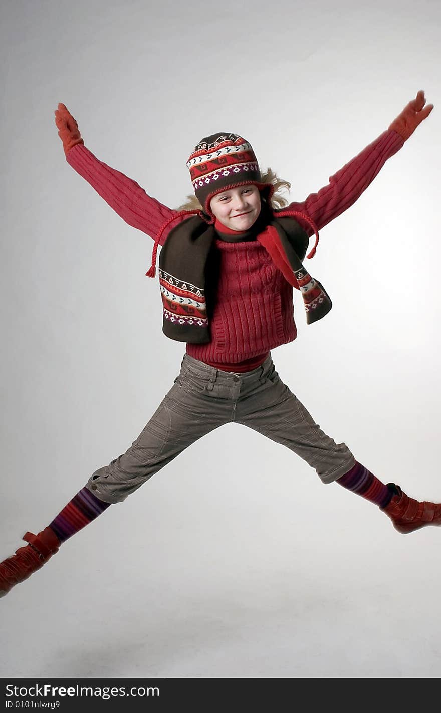 A girl jumping up with her hands in the air