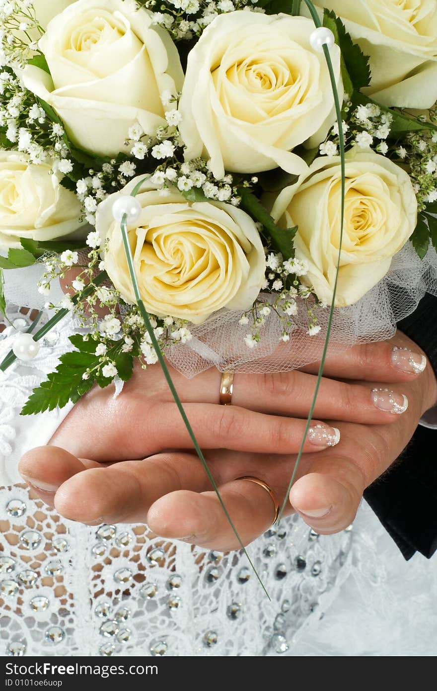 Wedding bouquet of roses holding by bride and groom. Wedding bouquet of roses holding by bride and groom