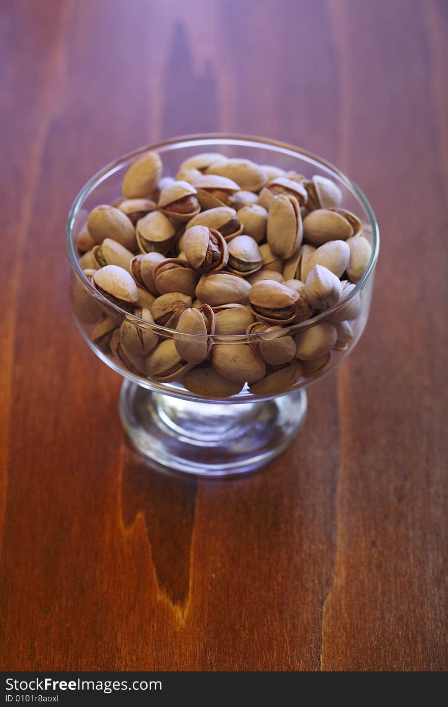 Bowl with pistachios on a table