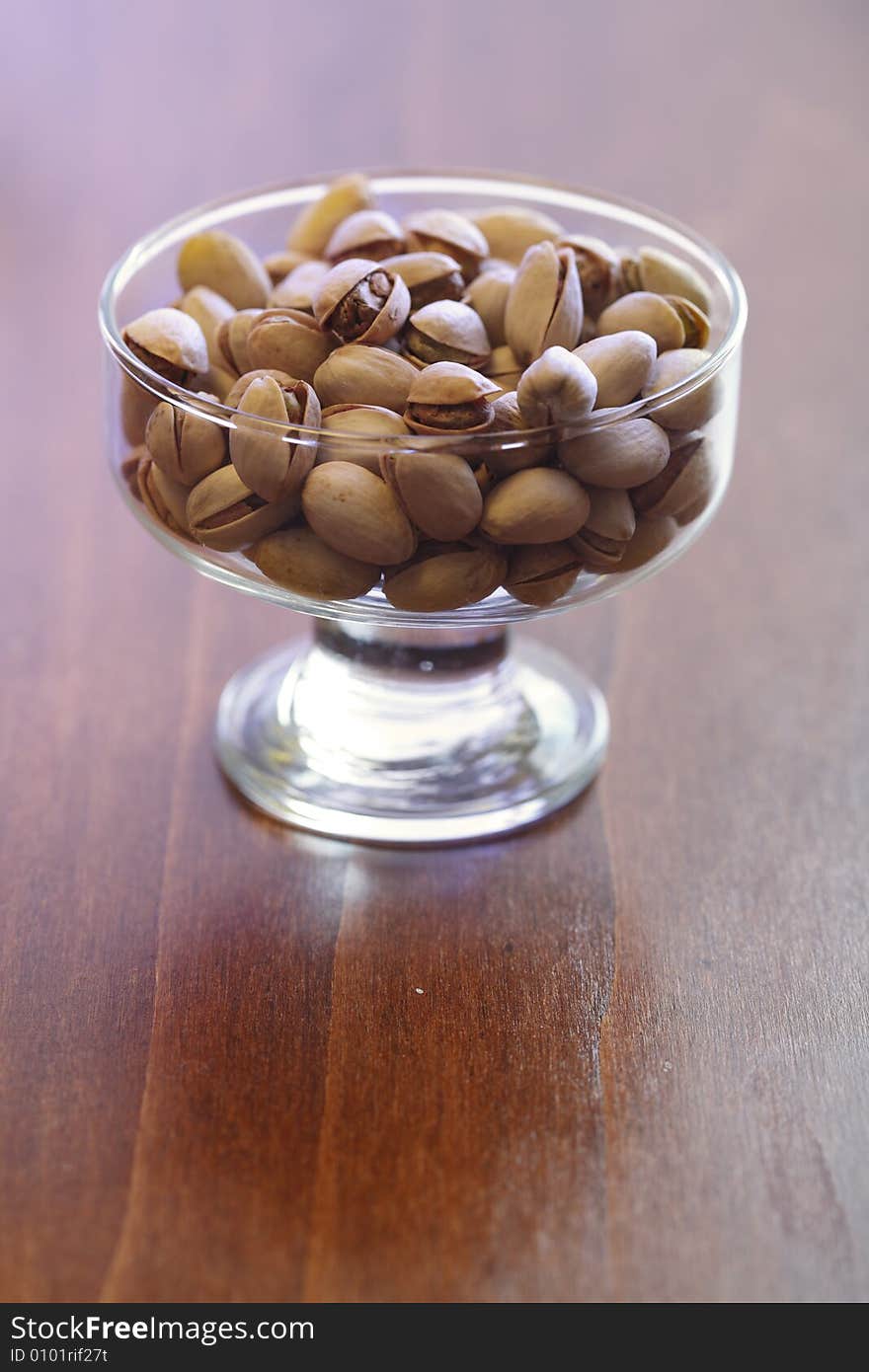 Bowl with pistachios on a table