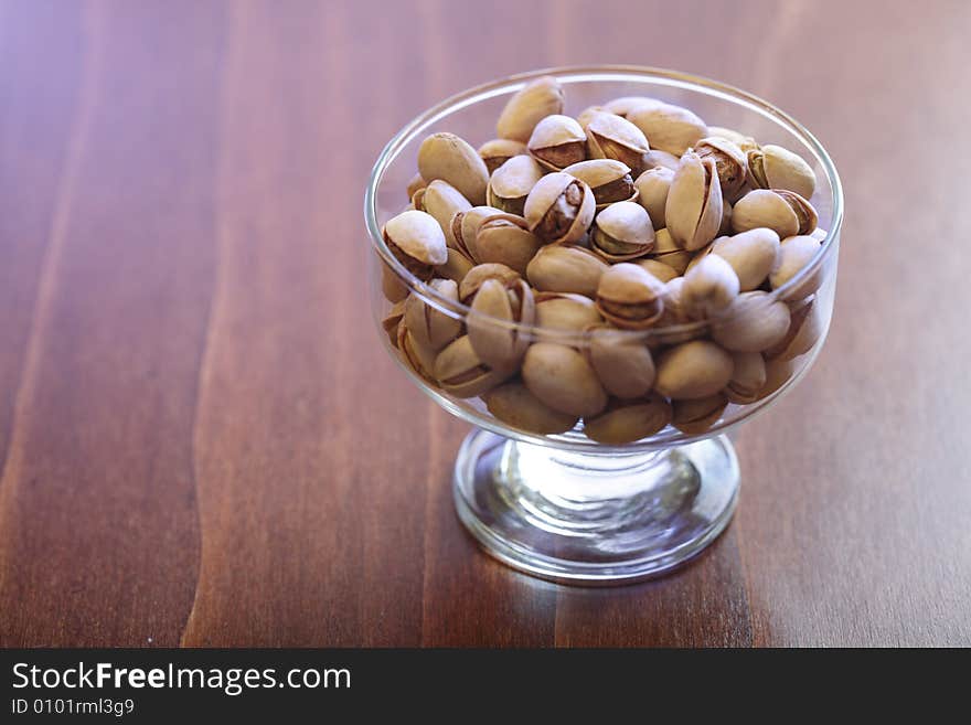 Bowl with pistachios on a table