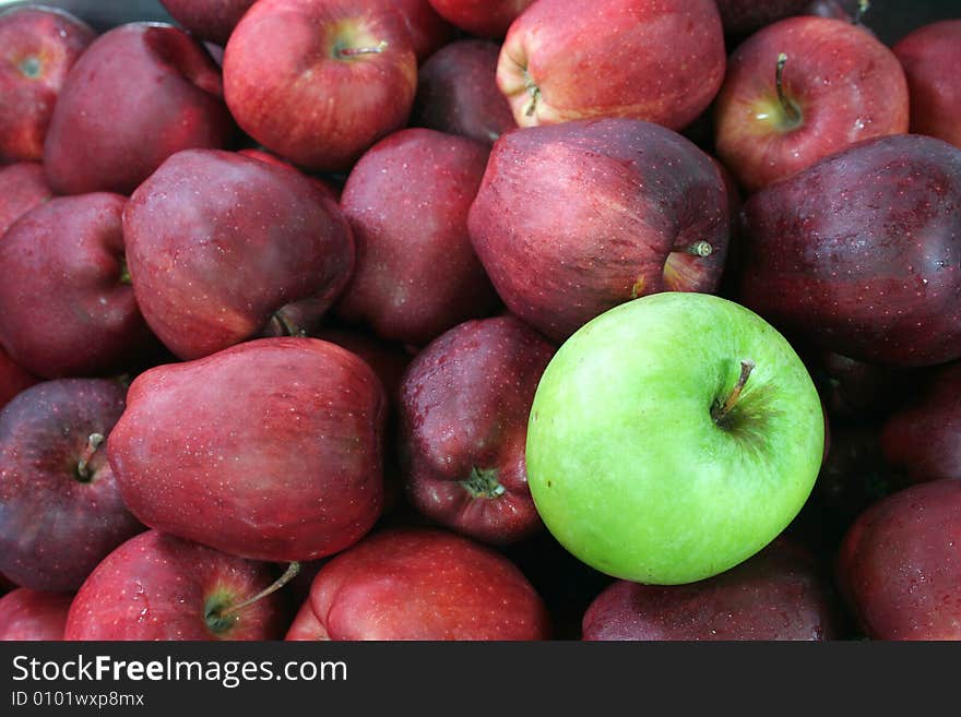 Green apples against red apple