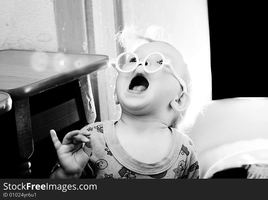 An image of a baby in toy-glasses. An image of a baby in toy-glasses