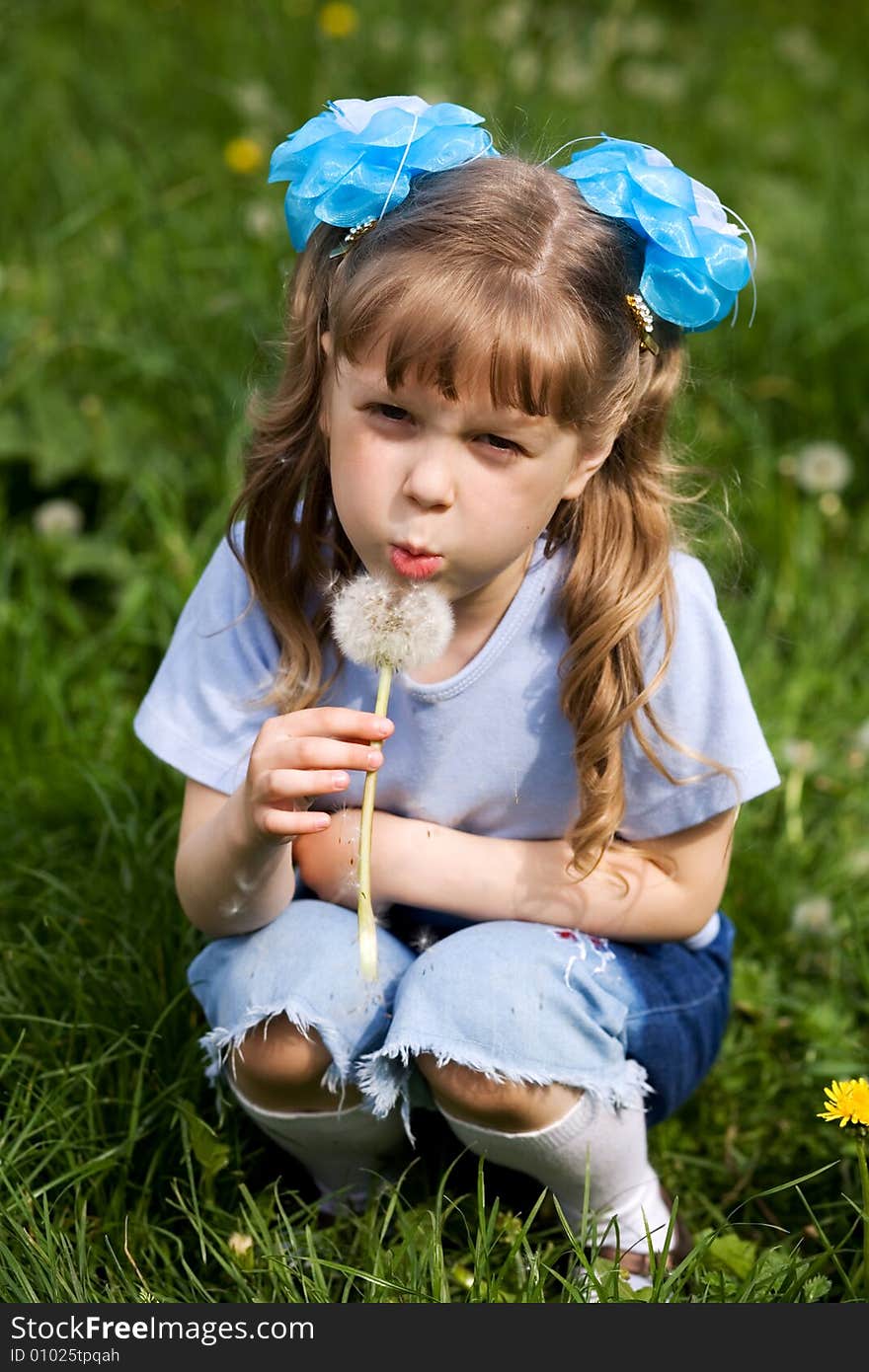 An image of a girl with white dandelion. An image of a girl with white dandelion