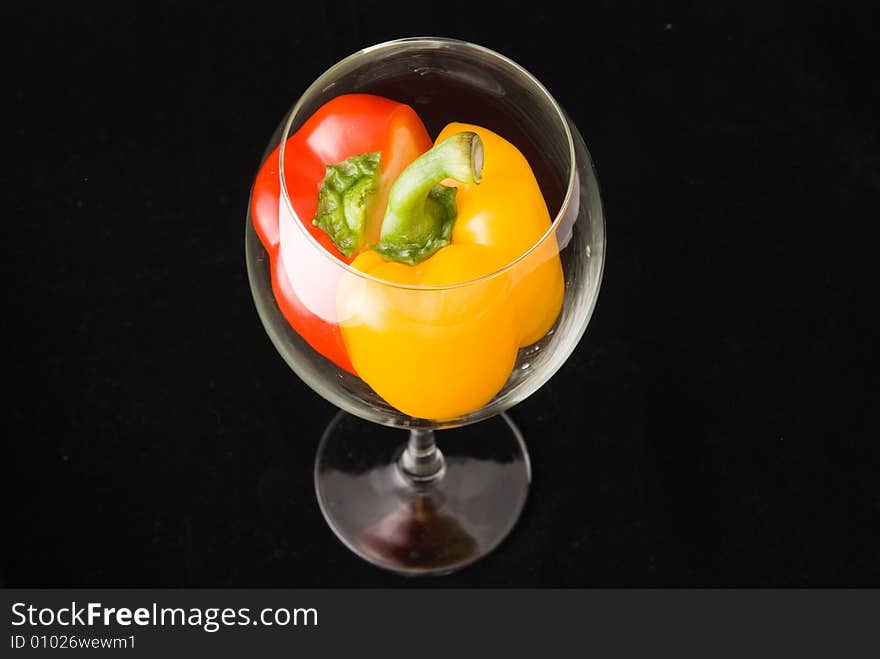 Beatiful dissected Pimiento united in bright goblet on black background. Beatiful dissected Pimiento united in bright goblet on black background