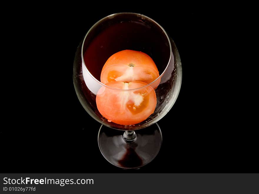 Fresh dissected tomato in bright glass goblet. Fresh dissected tomato in bright glass goblet