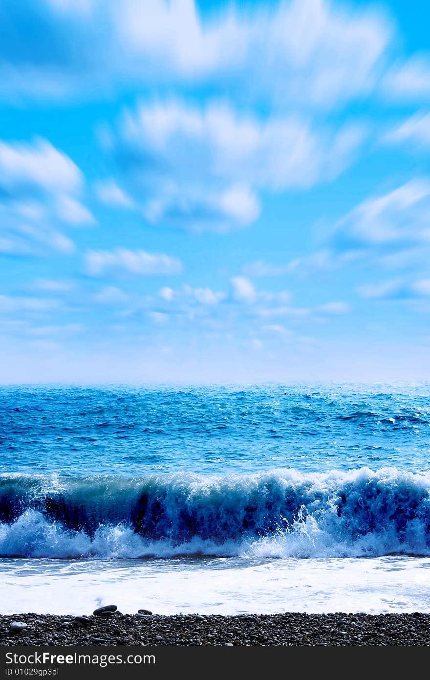 Wave on sea beach under year blue sky and cloud