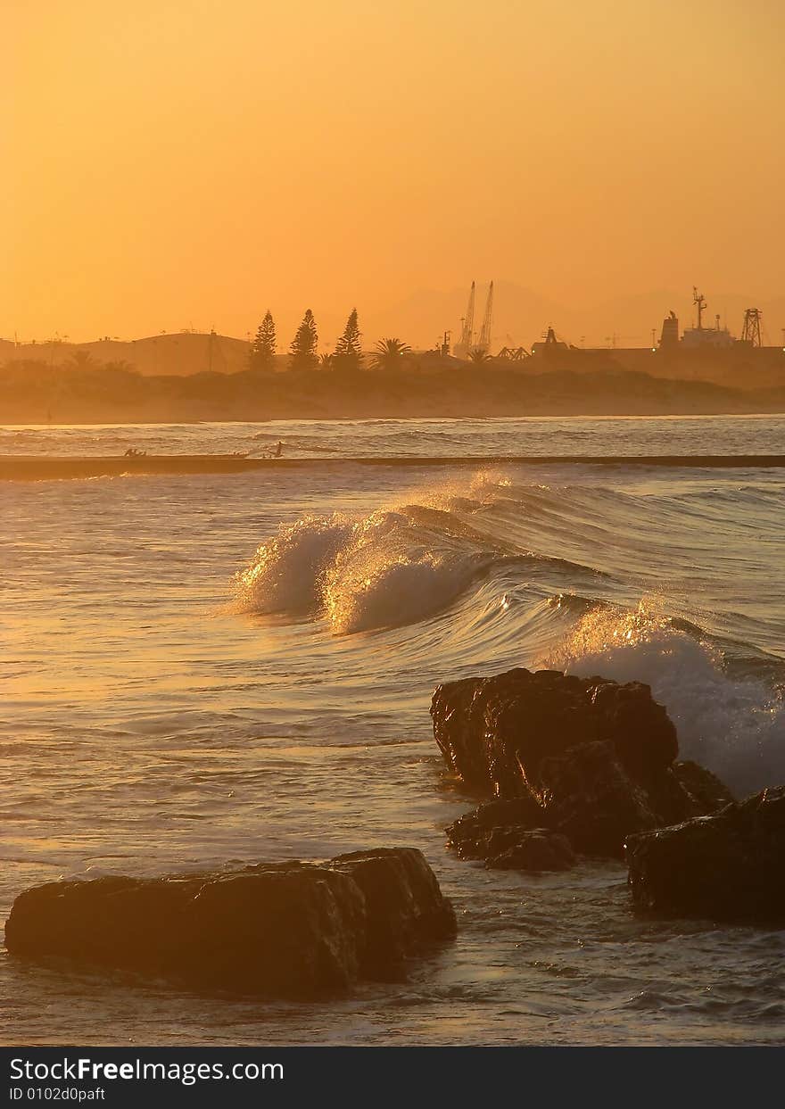 Waves and rocks at sunset