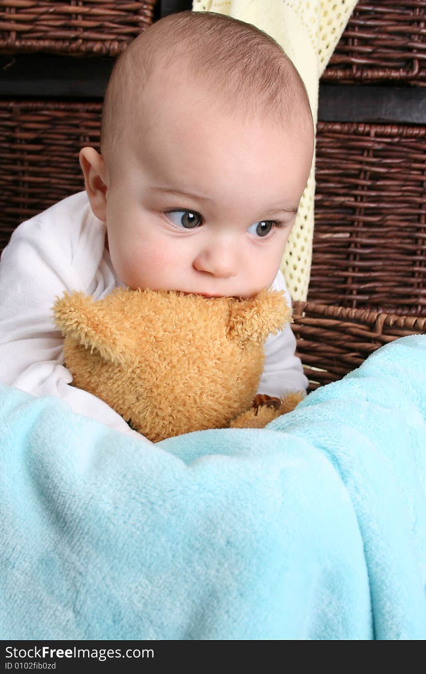 Six month old baby sitting infront of wooden drawers. Six month old baby sitting infront of wooden drawers