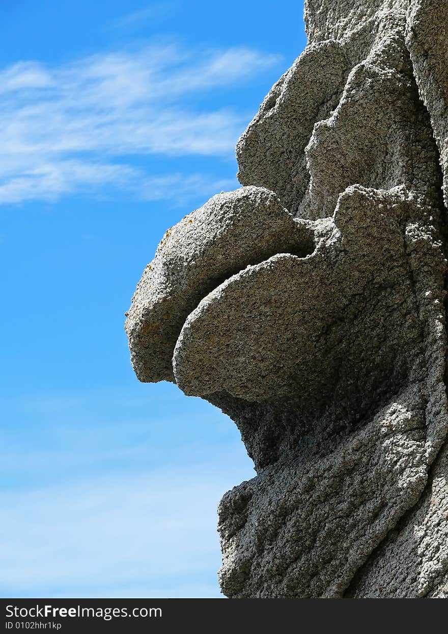 Rock of the unusual form with a prominence as a mouth of the fantastic monster. Sunny day.  Russian Far Easr, Primorye, Petrova island, nature state reserve Lazovsky. Rock of the unusual form with a prominence as a mouth of the fantastic monster. Sunny day.  Russian Far Easr, Primorye, Petrova island, nature state reserve Lazovsky.