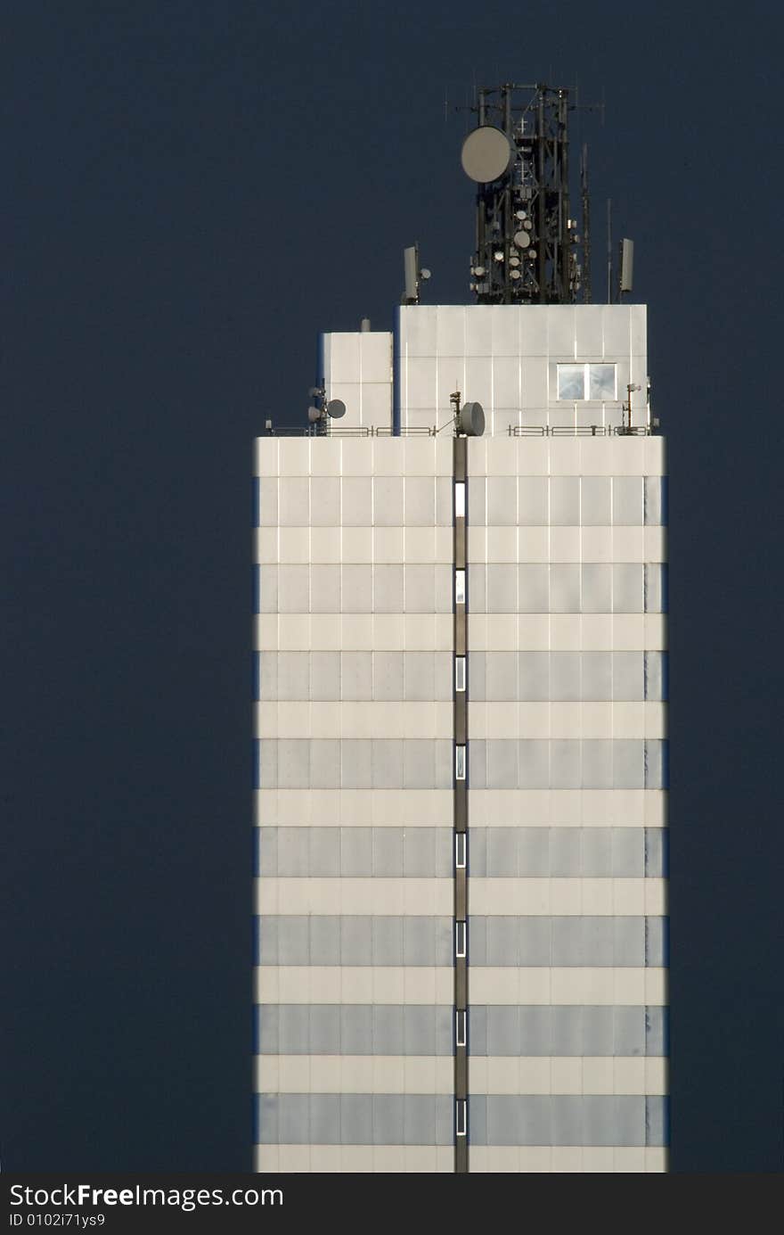 A skyscraper in front of black sky