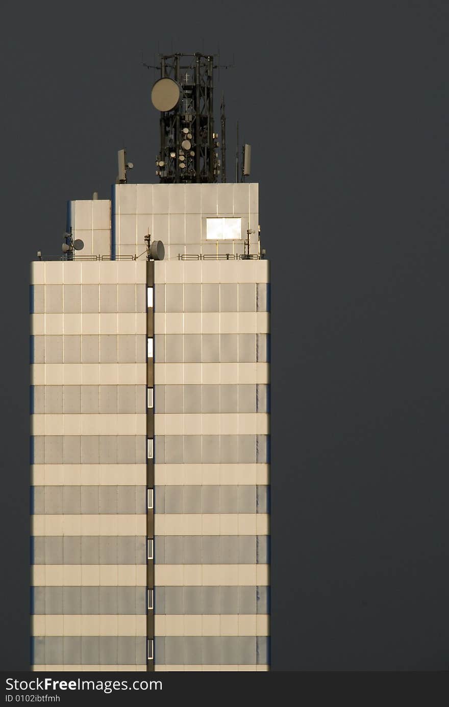 A skyscraper in front of black sky