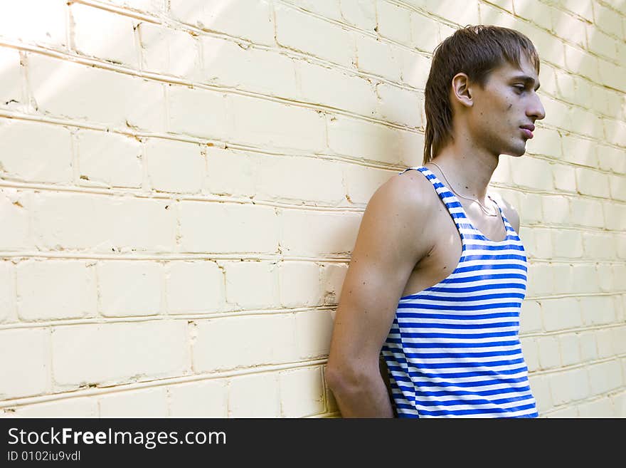 Handsome young man near wall