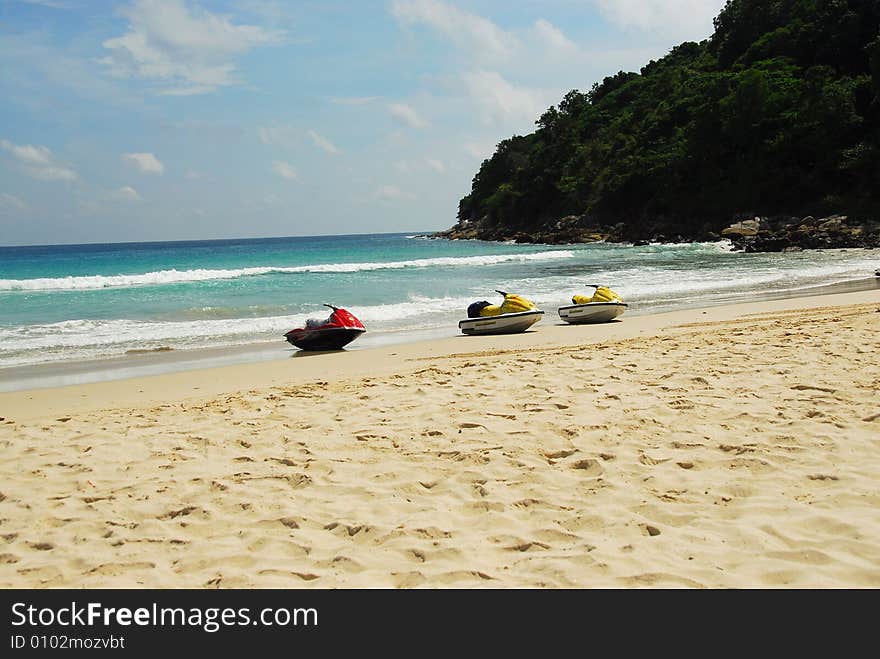 Three empty water scooter or jet ski waiting on beach at sea. Three empty water scooter or jet ski waiting on beach at sea