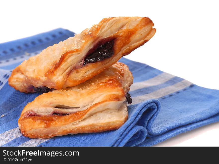 Two blueberry turnovers on a napkin