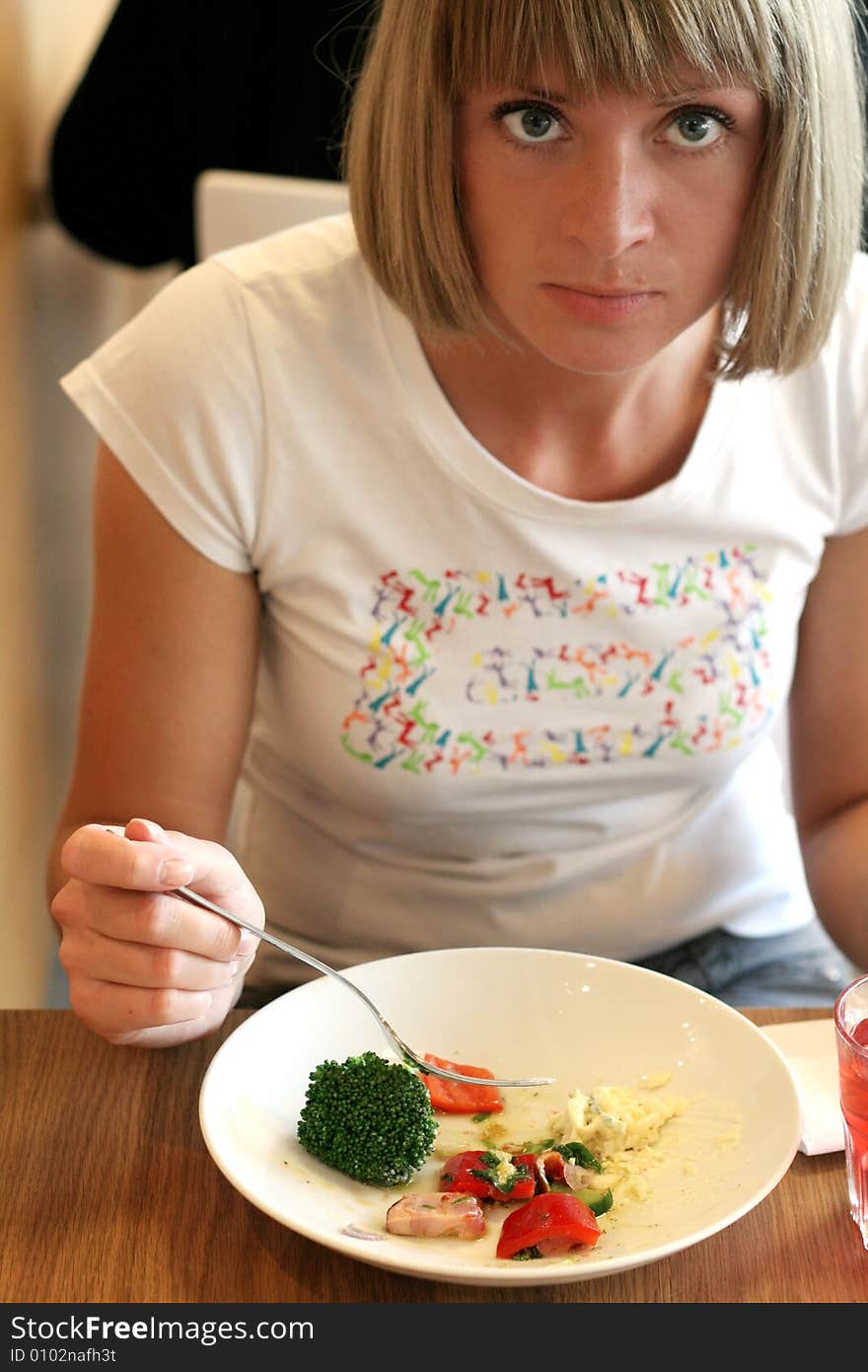 Beautiful young woman eating vegetables. Beautiful young woman eating vegetables