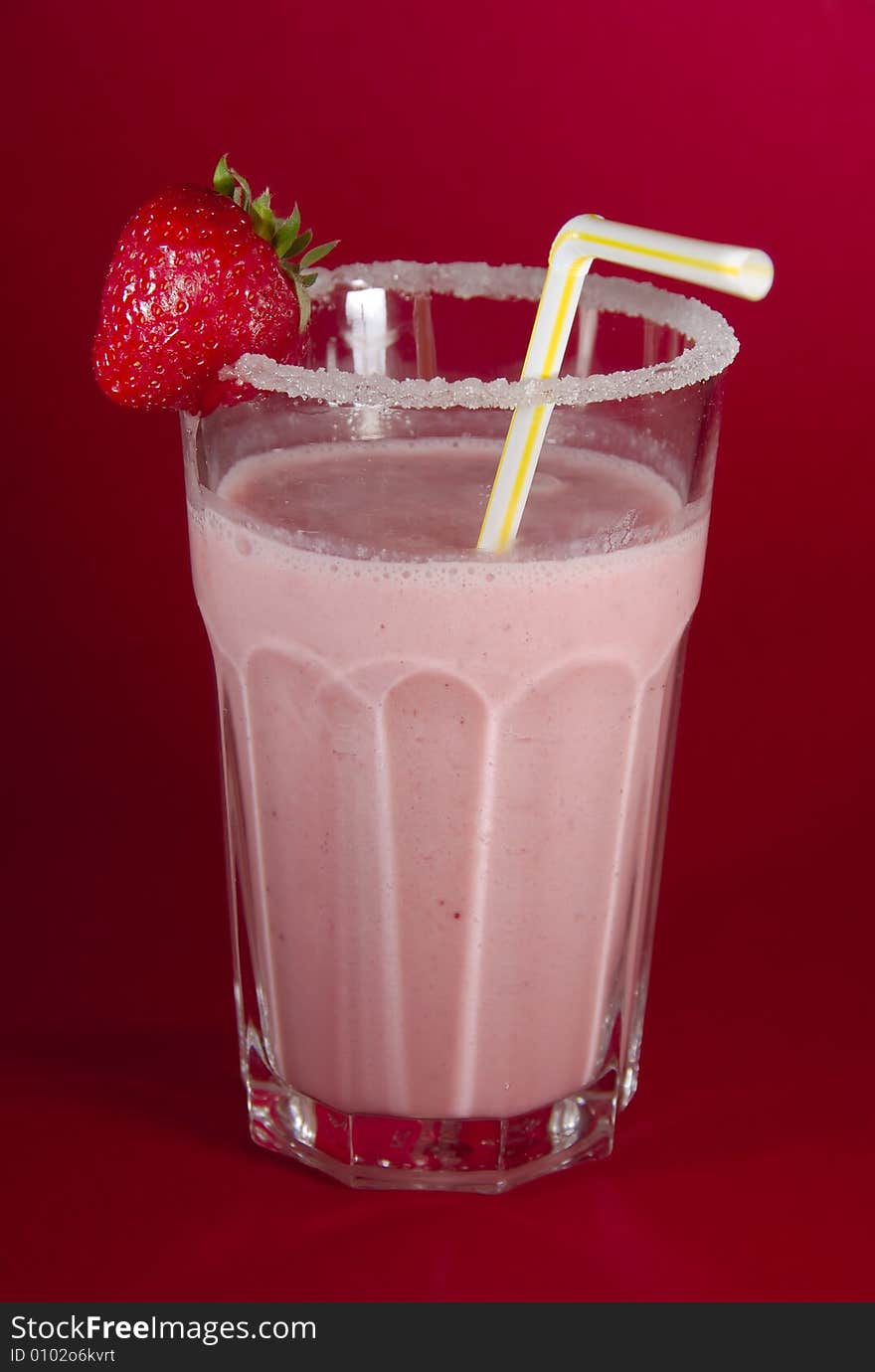 Pink milkshake, with strawberry and straw. Pink milkshake, with strawberry and straw