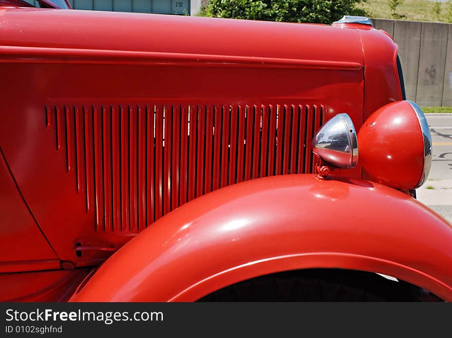 Hood, fender and headlight of an antique 1937 Dodge red fire engine. Hood, fender and headlight of an antique 1937 Dodge red fire engine.