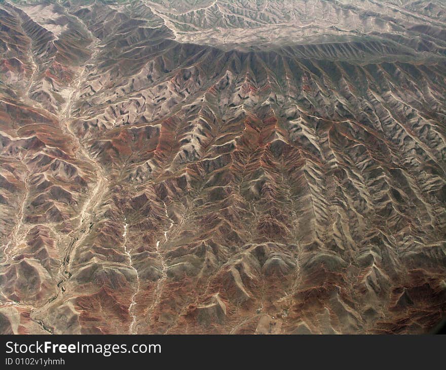 Take the photo from airplane near Urumqi. the mountain is part of Ttianshan mountains in SinKiang, China.