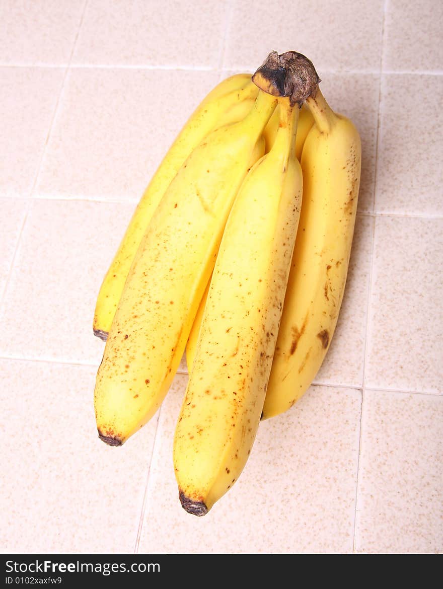 A banana on a kitchen counter top. A banana on a kitchen counter top