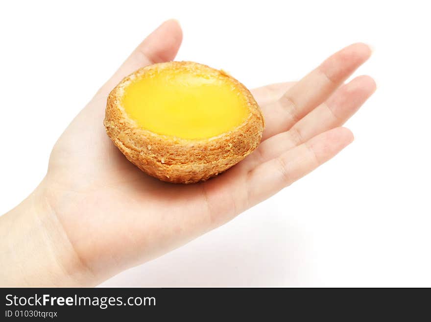 An egg tart holding on a lady hand. An egg tart holding on a lady hand.