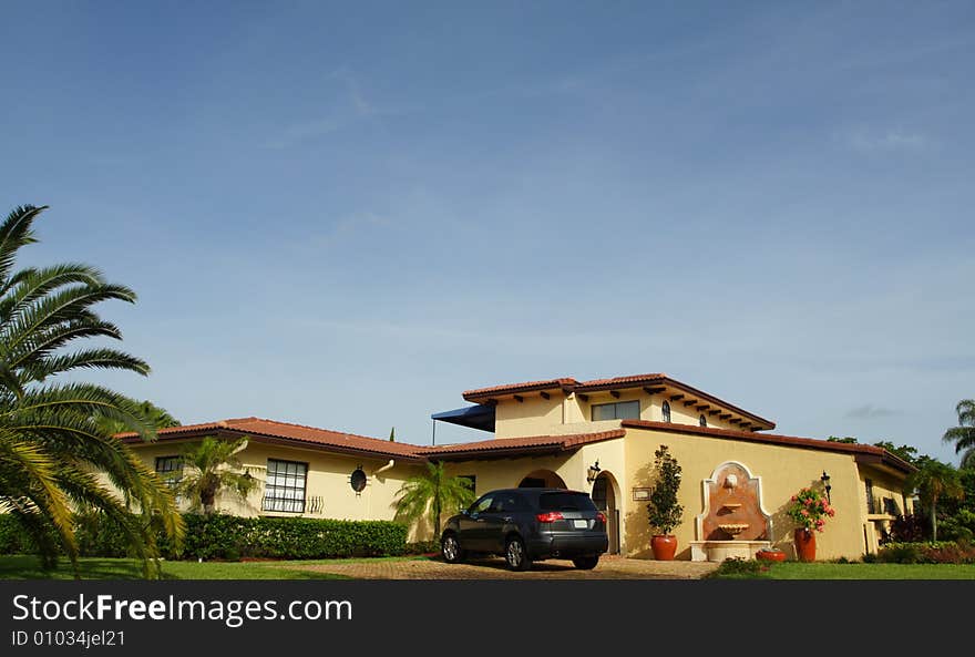 Luxury home with a luxury suv in the driveway. Luxury home with a luxury suv in the driveway.