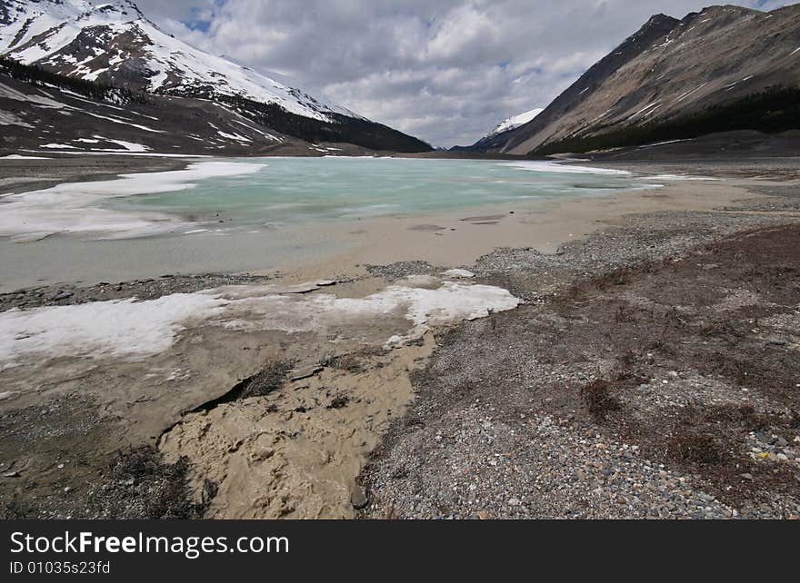 Dirty water running towards a beautiful clear lake. Dirty water running towards a beautiful clear lake.