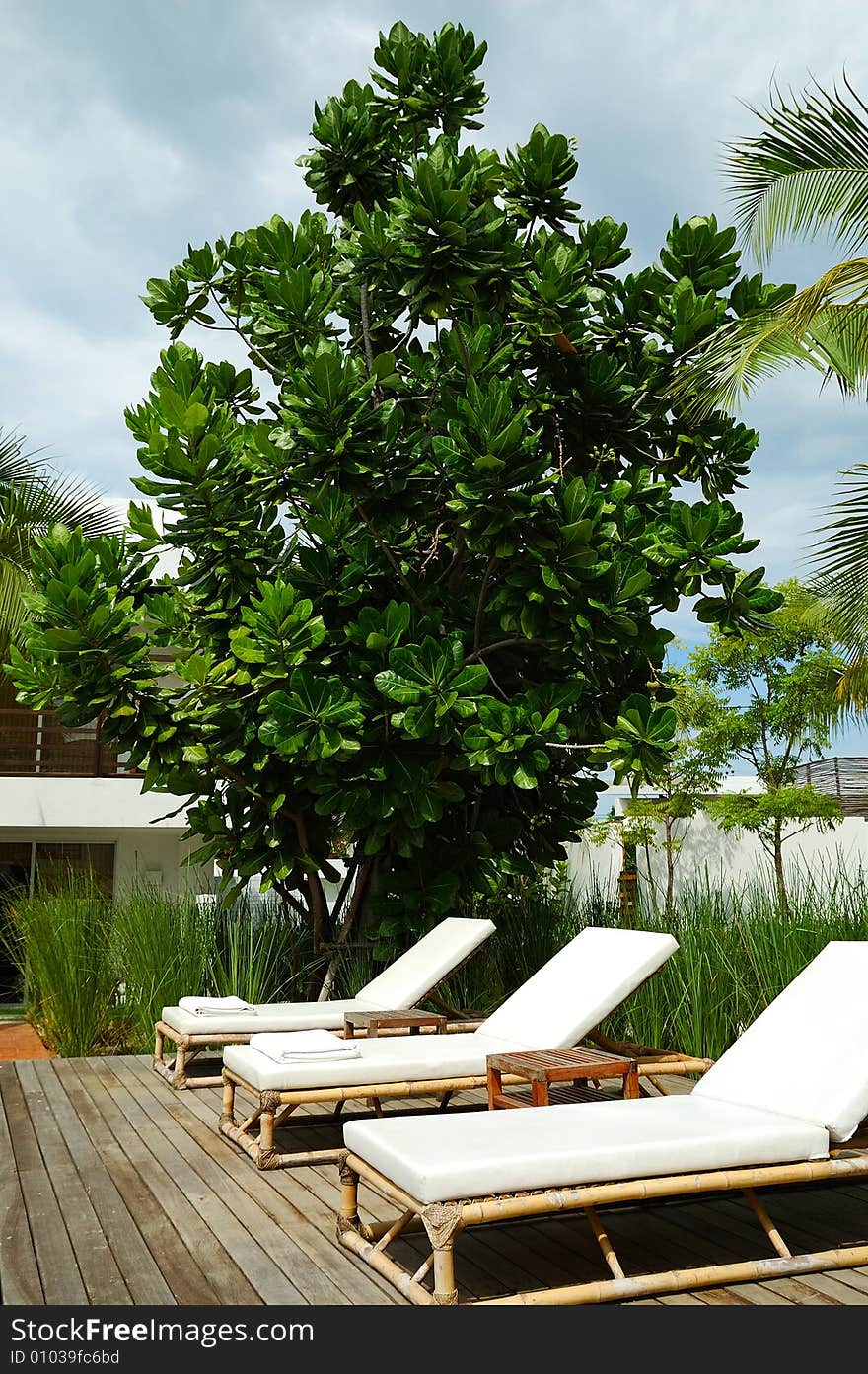 White trestle-beds near the resort's pool