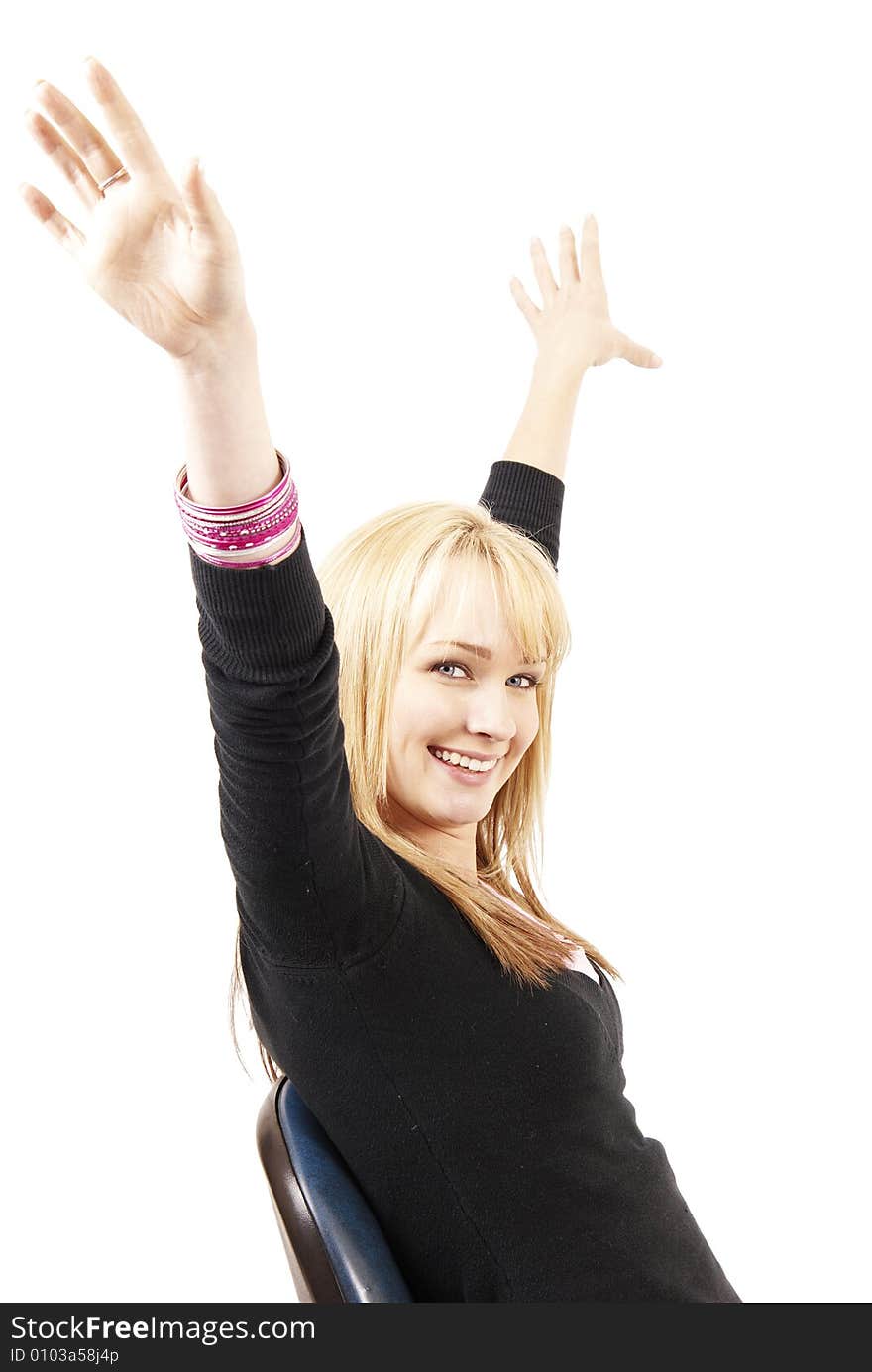 Beautiful blonde business woman with natural makeup with her hands in the air while sitting on a chair. Beautiful blonde business woman with natural makeup with her hands in the air while sitting on a chair