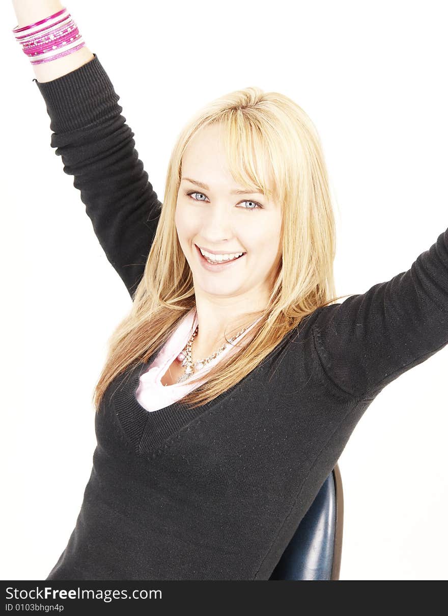 Beautiful blonde business woman with natural makeup sitting on a chair with her hand in the air. Beautiful blonde business woman with natural makeup sitting on a chair with her hand in the air