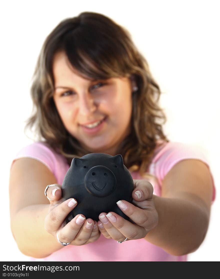 Young lady holding piggy bank in front of him with focus on piggy bank