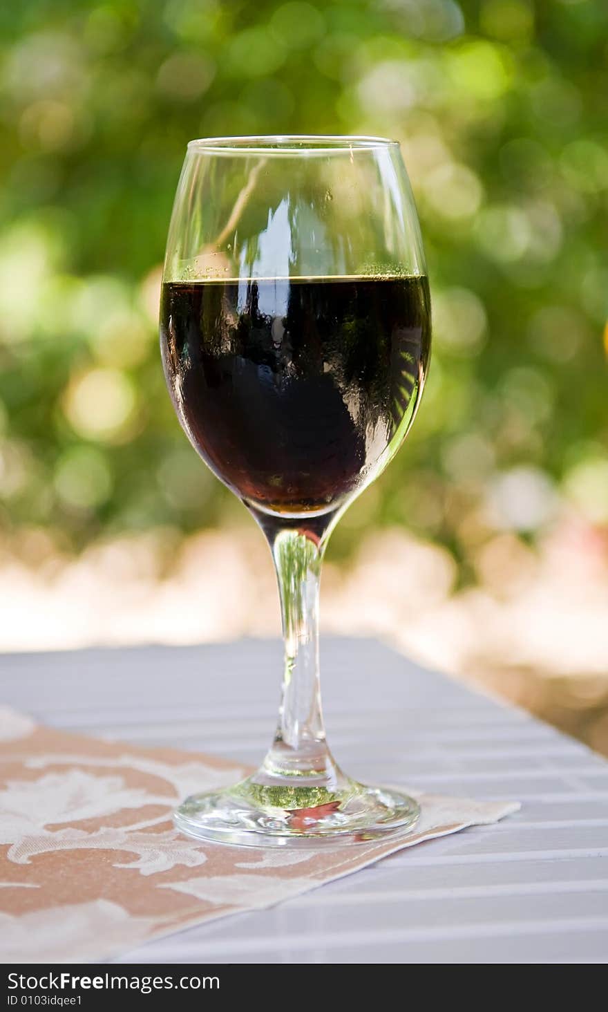 Glass of soda on garden teble in hot summer