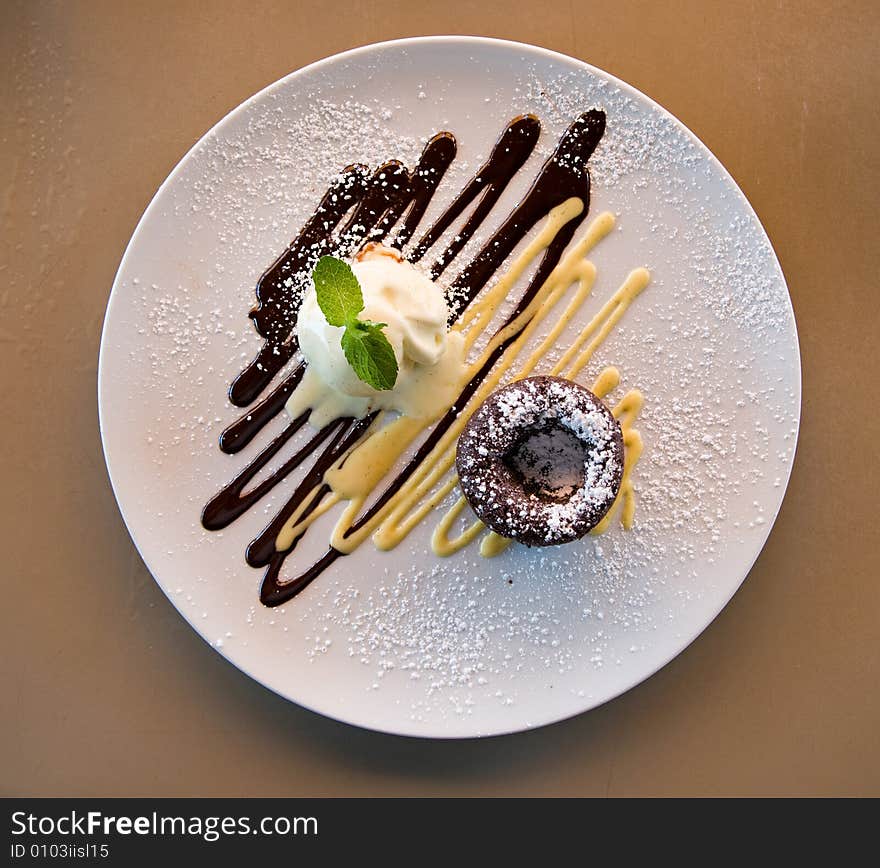 Chocolate cake on a decorated plate with vanilla ice cream. Chocolate cake on a decorated plate with vanilla ice cream