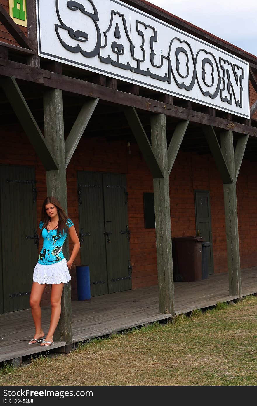 Young woman on the sunny day in the old  western town. Young woman on the sunny day in the old  western town