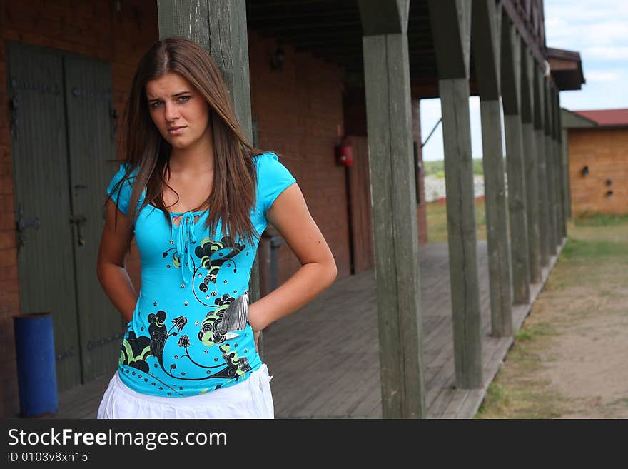 Portrait of a young woman on the sunny day in the old  western town. Portrait of a young woman on the sunny day in the old  western town