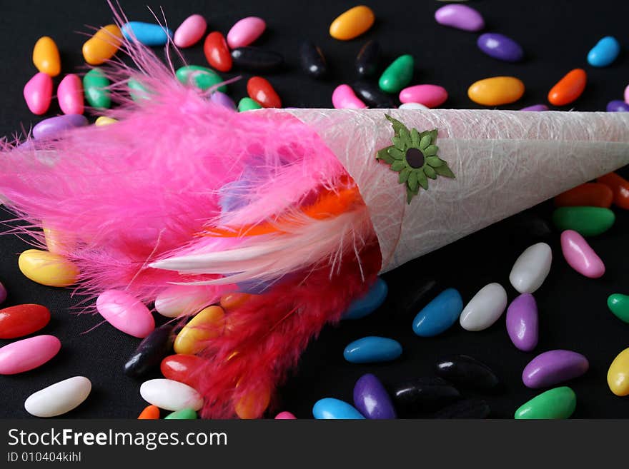 Brightly colored feather confetti in a cone