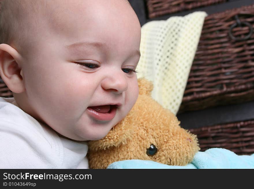 Six month old baby sitting infront of wooden drawers. Six month old baby sitting infront of wooden drawers