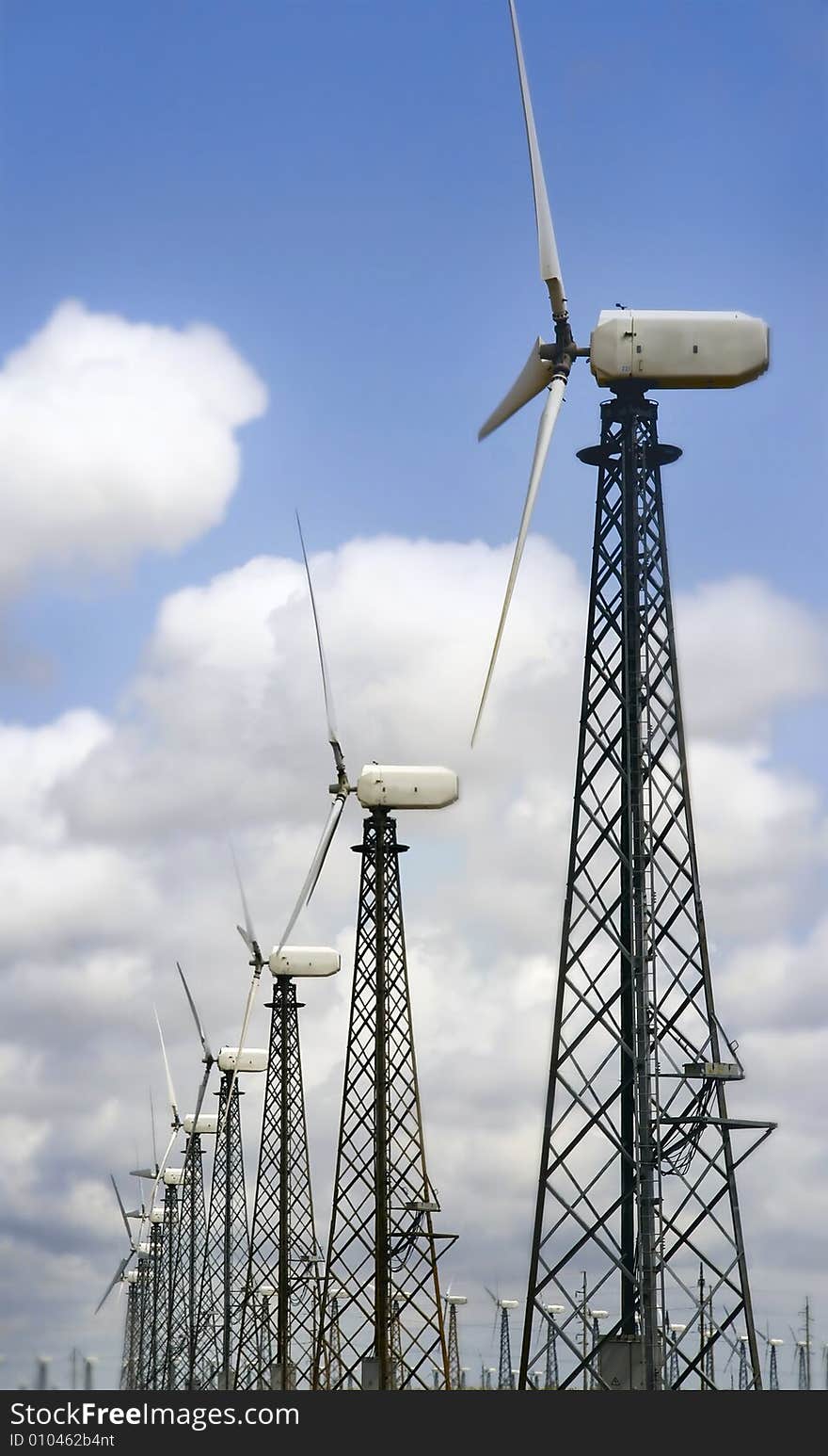 Group of windturbines over sky background