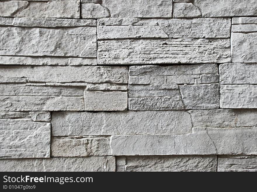 A wall made of grey stone bricks. A wall made of grey stone bricks